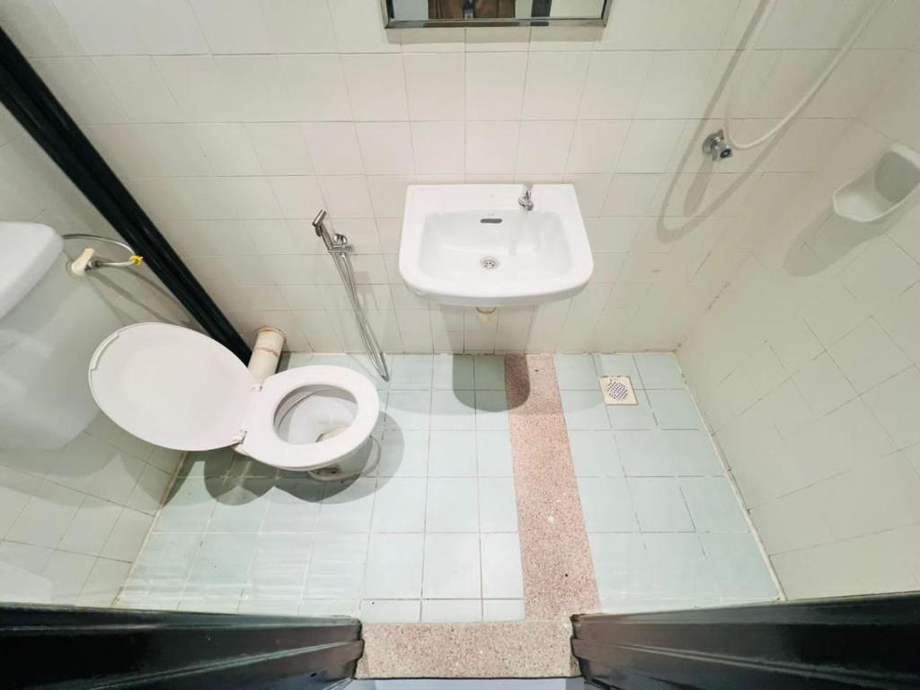 a bathroom with a toilet and a sink at AVENUE RESIDENCE in Kuala Lumpur