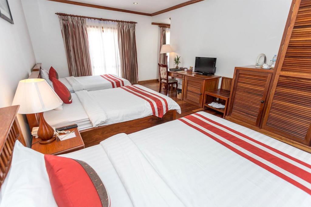 Postel nebo postele na pokoji v ubytování Cheathata CTA Hotel Siem Reap
