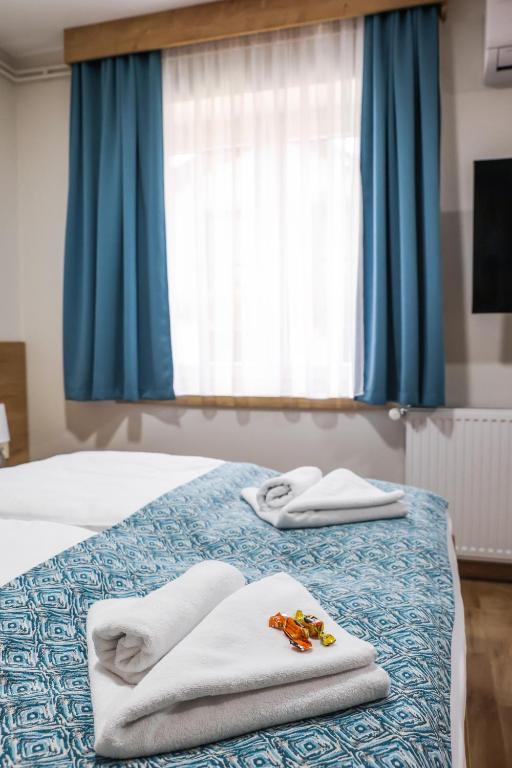 Postel nebo postele na pokoji v ubytování Grand Park rooms & apartments