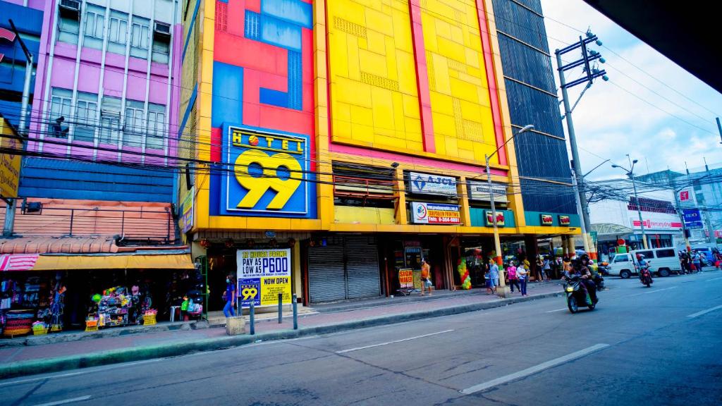 a colorful building on the side of a city street at Hotel 99 Monumento in Manila