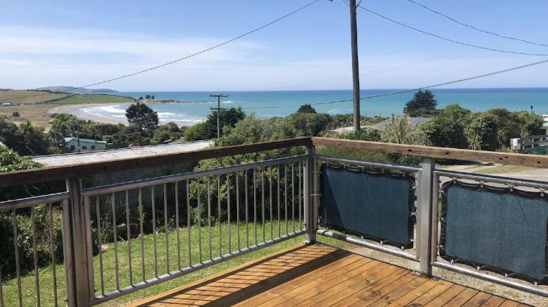 a balcony with a view of the ocean at Beachbach16 - Kakanui in Kakanui