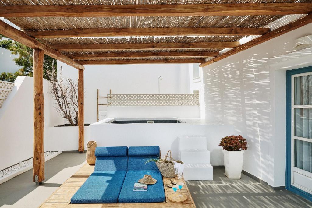 a room with a blue couch on a patio at Chrysalis Boutique - Adults Only in Astypalaia Town