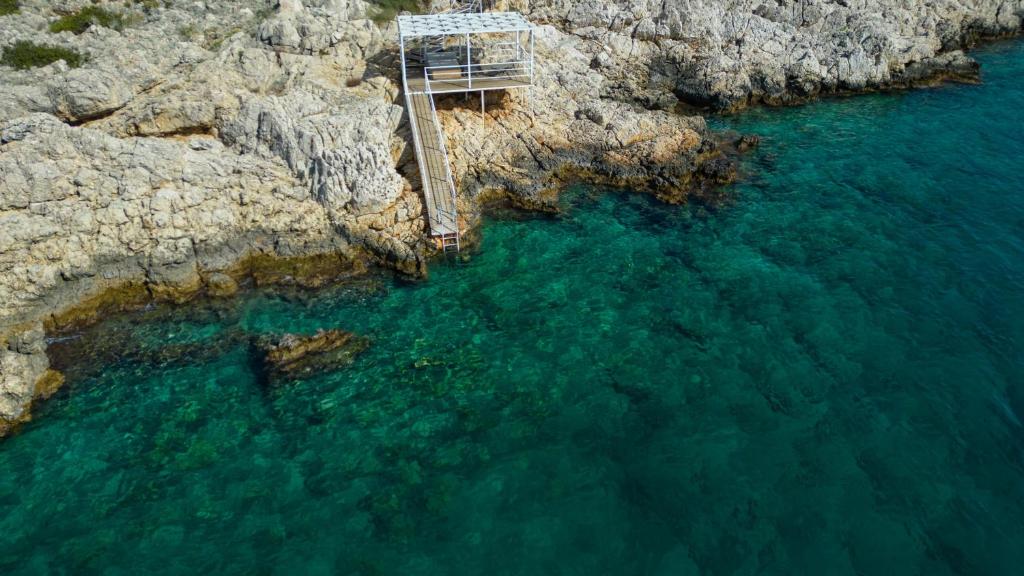 an aerial view of a bridge over a body of water at BEACHFRONT SARI VILLA WİTH PRIVATE SWIMMING POOL in Kalkan