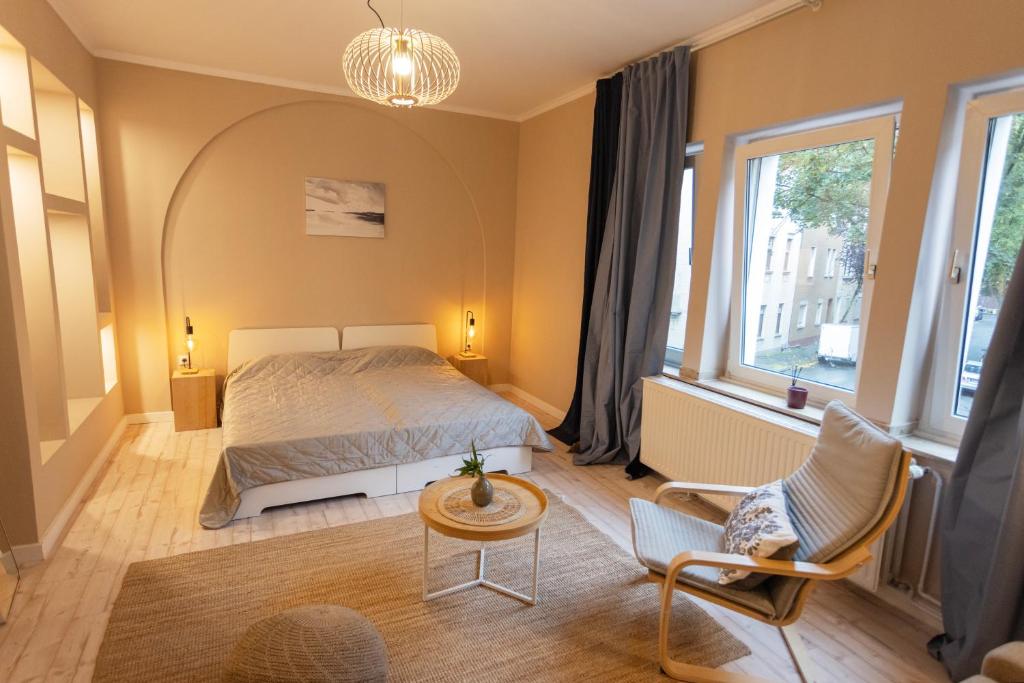 1 dormitorio con 1 cama, mesa y sillas en Huge apartment with Sauna and free parking, en Duisburg