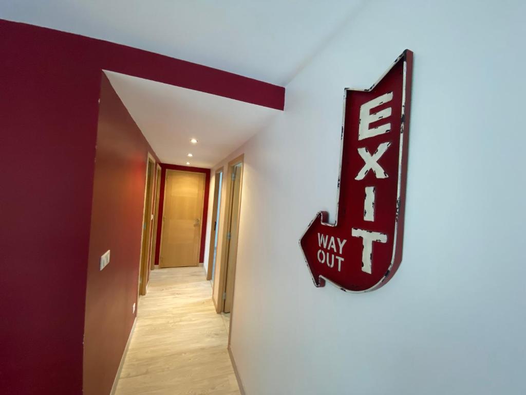 a hallway with a way out sign on a wall at Grange rénovée esprit loft Côte d&#39;Opale in Wierre-Effroy