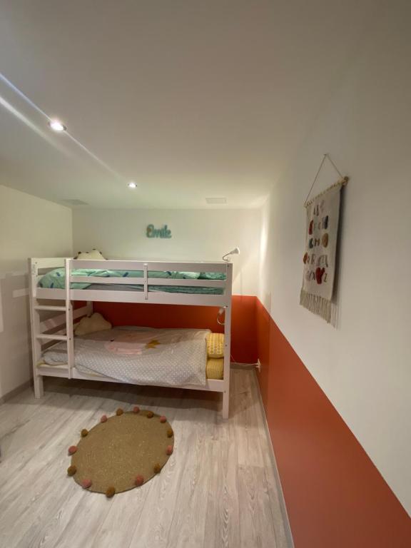 a small room with a bunk bed and a rug at Grange rénovée esprit loft Côte d&#39;Opale in Wierre-Effroy
