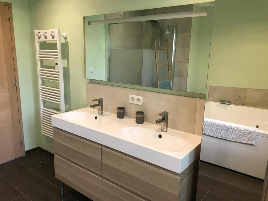 a bathroom with a sink and a mirror at Grange rénovée esprit loft Côte d&#39;Opale in Wierre-Effroy