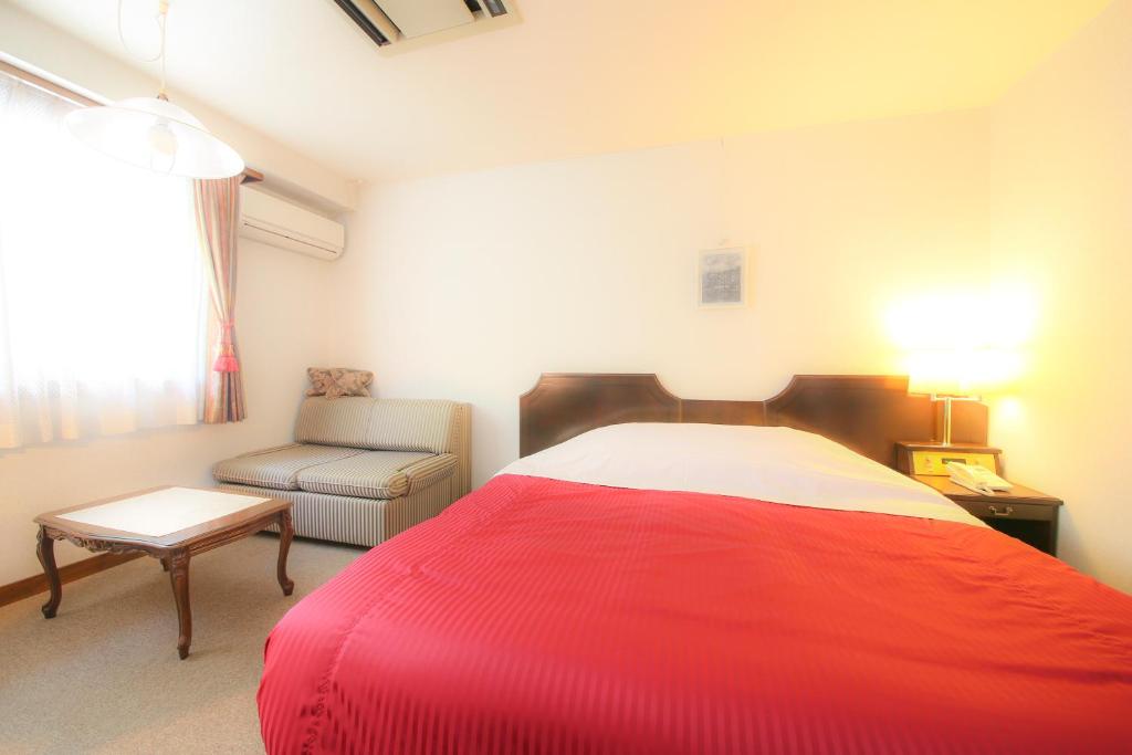 Postel nebo postele na pokoji v ubytování Hotel Soyokaze