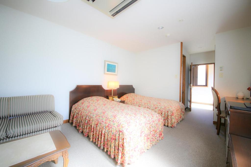 Postel nebo postele na pokoji v ubytování Hotel Soyokaze