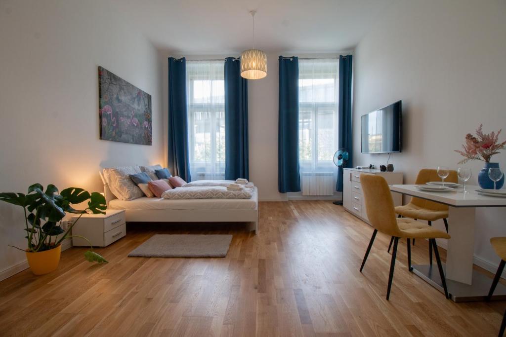 a living room with a couch and a table at Washingtonova CR apartments in Prague