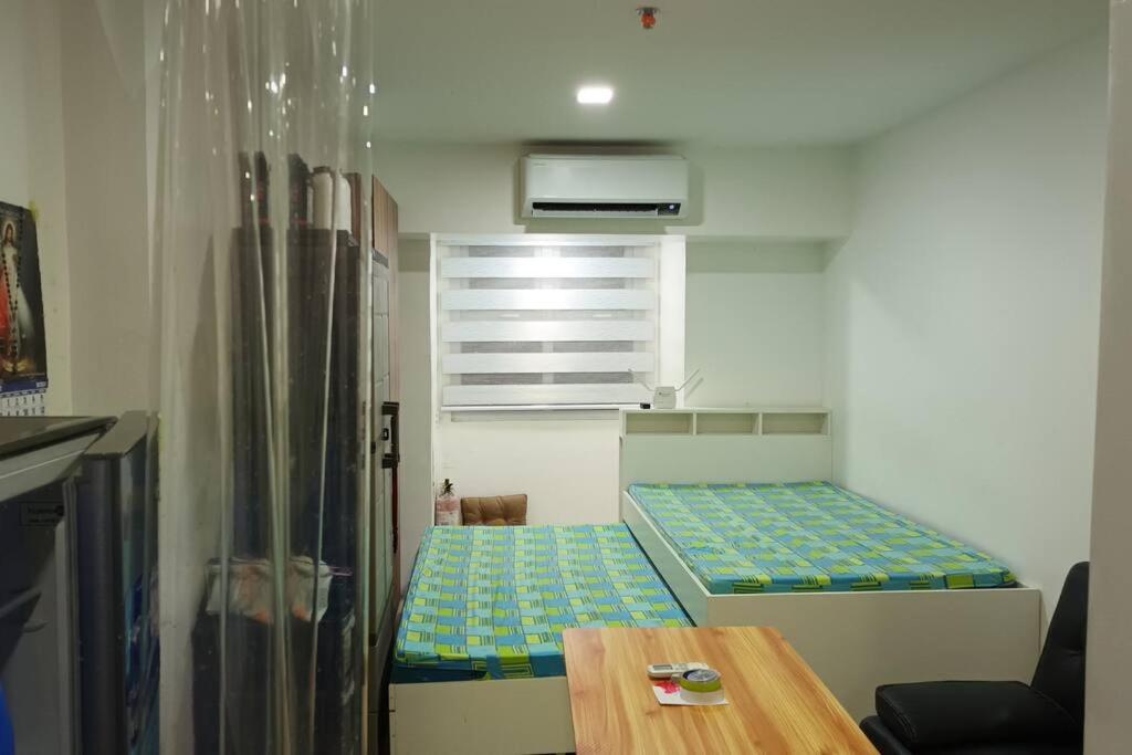 a small room with a bunk bed and a table at Apartment Unit in Downtown Manila in Manila