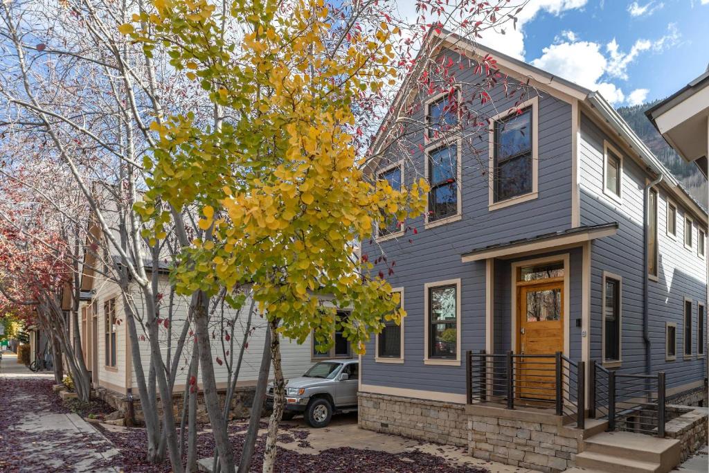 a blue house with a tree in front of it at West Pacific Ave 320 ~ Pacifico in Telluride