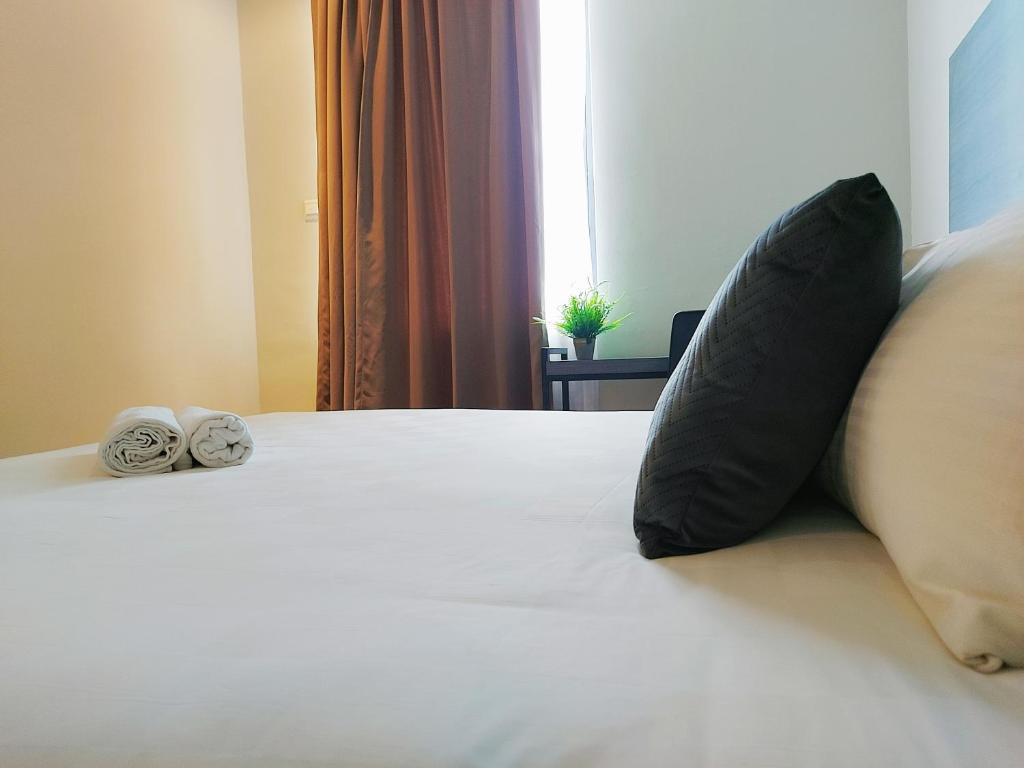 Ένα ή περισσότερα κρεβάτια σε δωμάτιο στο The Leverage Business Hotel - Bandar Baru Mergong
