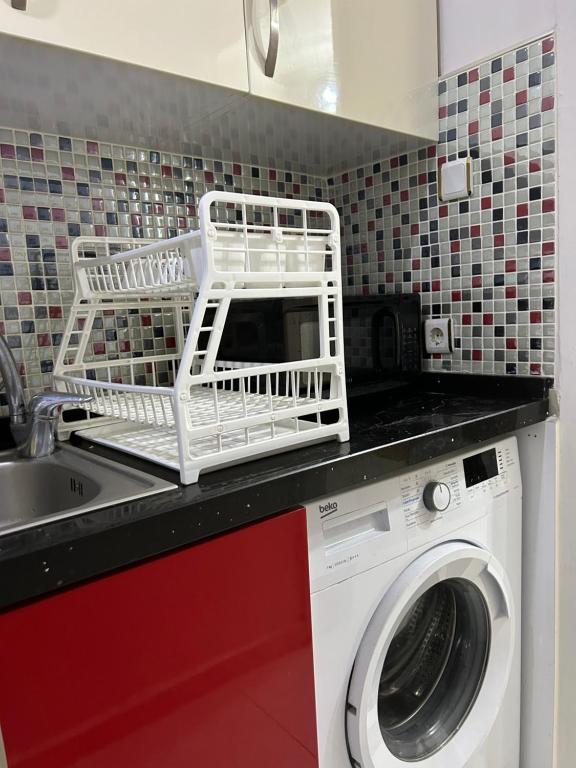 a kitchen with a washing machine and a sink at 1+1 apartment in heart of kadikoy in Istanbul