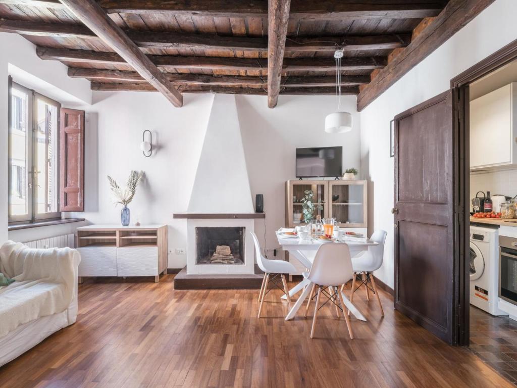 a living room with a table and a fireplace at The Best Rent - Elegant apartment in Trastevere in Rome