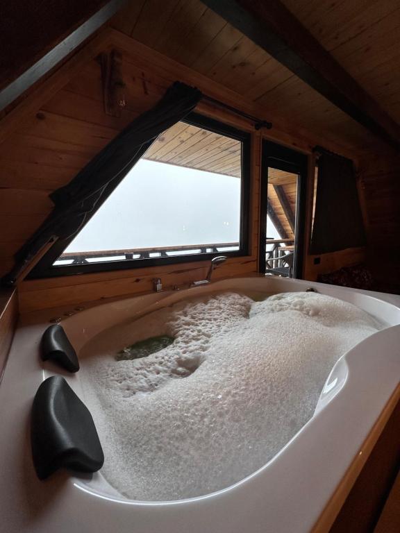 a bath tub in a room with a window at VİRA TAŞ KONAK in Trabzon