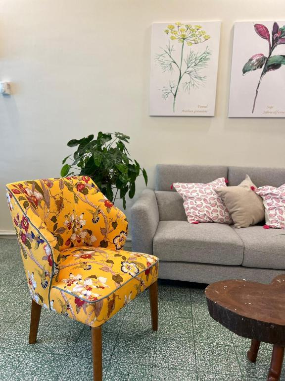 a living room with a chair and a couch at myROOM @ Mandalay Georgetown, Off Jln Burma, Gurney Drive in George Town