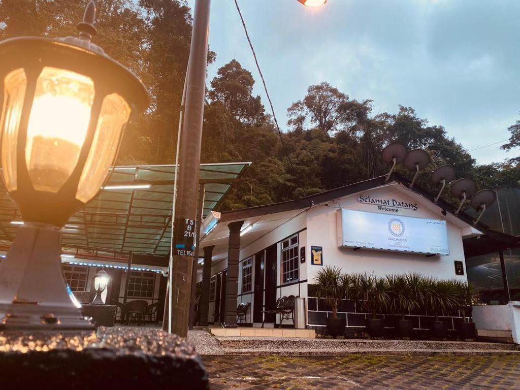 a building with a light post in front of it at Darulmakmur Chalet in Cameron Highlands