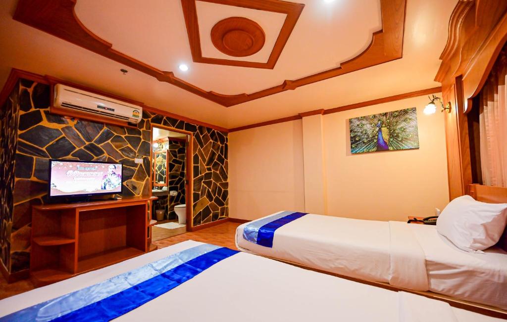 Postel nebo postele na pokoji v ubytování Tiger Complex Hotel