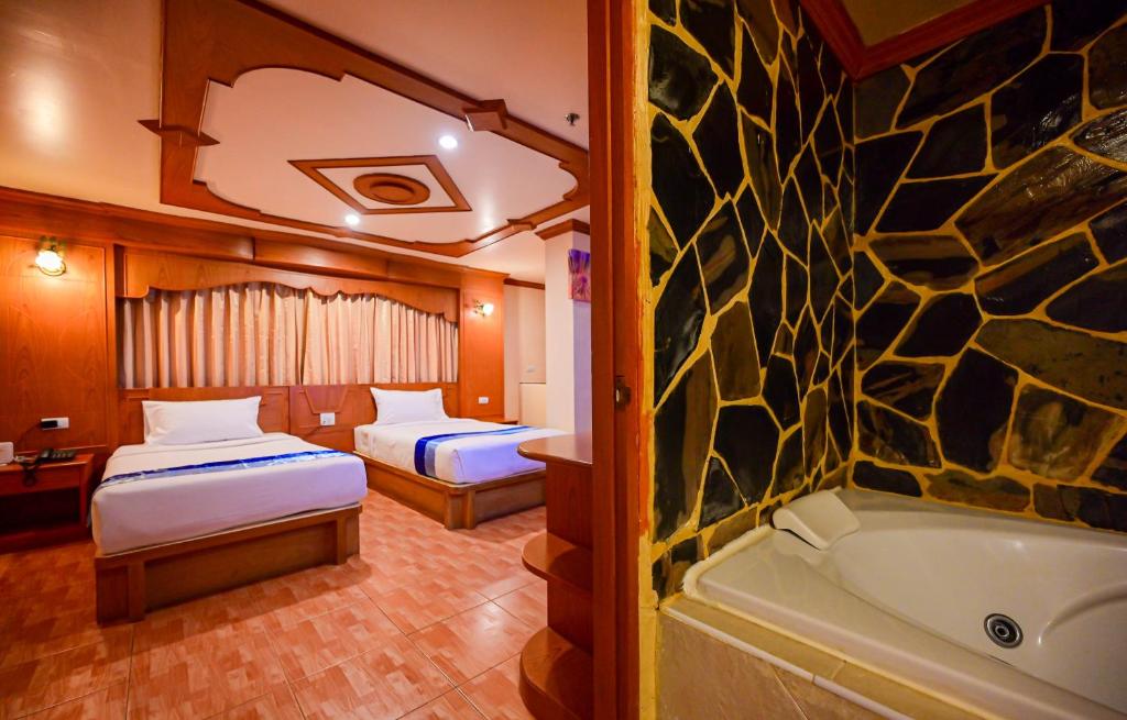 Postel nebo postele na pokoji v ubytování Tiger Complex Hotel