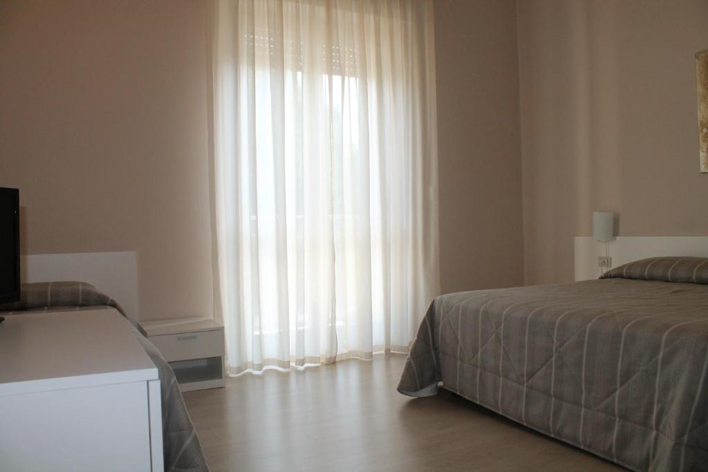 Postel nebo postele na pokoji v ubytování Hotel Cremona Viale