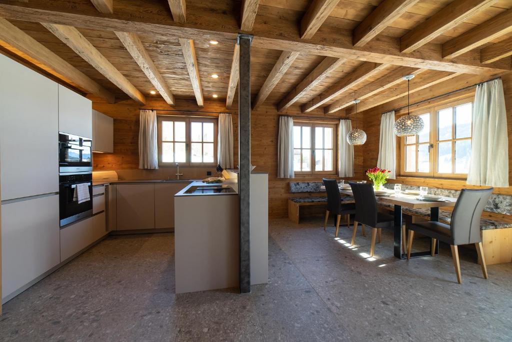 a kitchen and dining room with a table and chairs at Chalet Zuestoll in Wildhaus