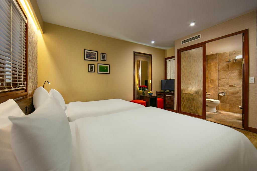 Postel nebo postele na pokoji v ubytování Oriental Suites Hotel & Spa