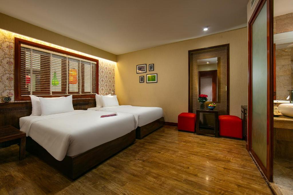 Postel nebo postele na pokoji v ubytování Oriental Suites Hotel & Spa
