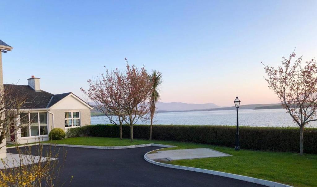 a house with a driveway next to the water at Seapoint Lodge in Westport
