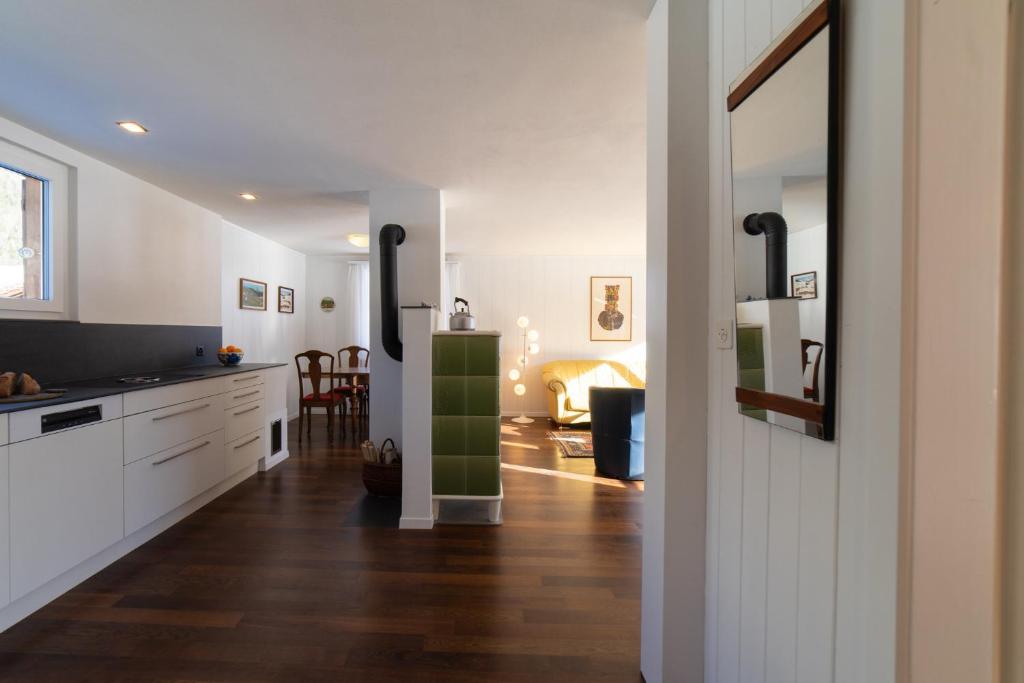 a kitchen with white cabinets and a green door at Sonnhalde in Wildhaus