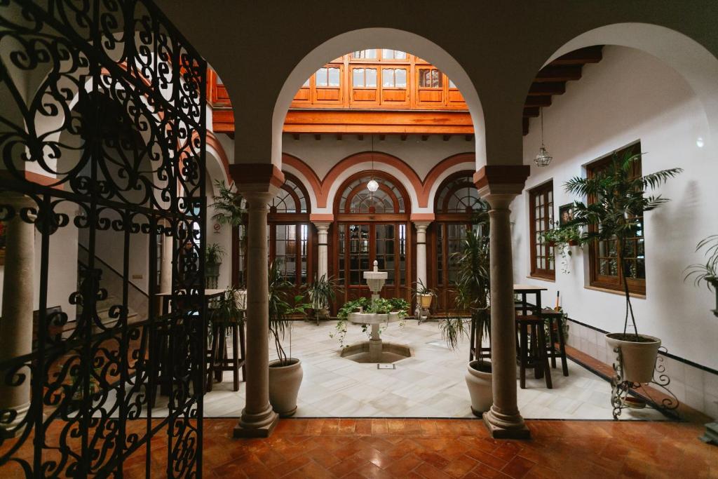 an indoor courtyard with plants in a building at One & Lux Casa Maravilla in Seville