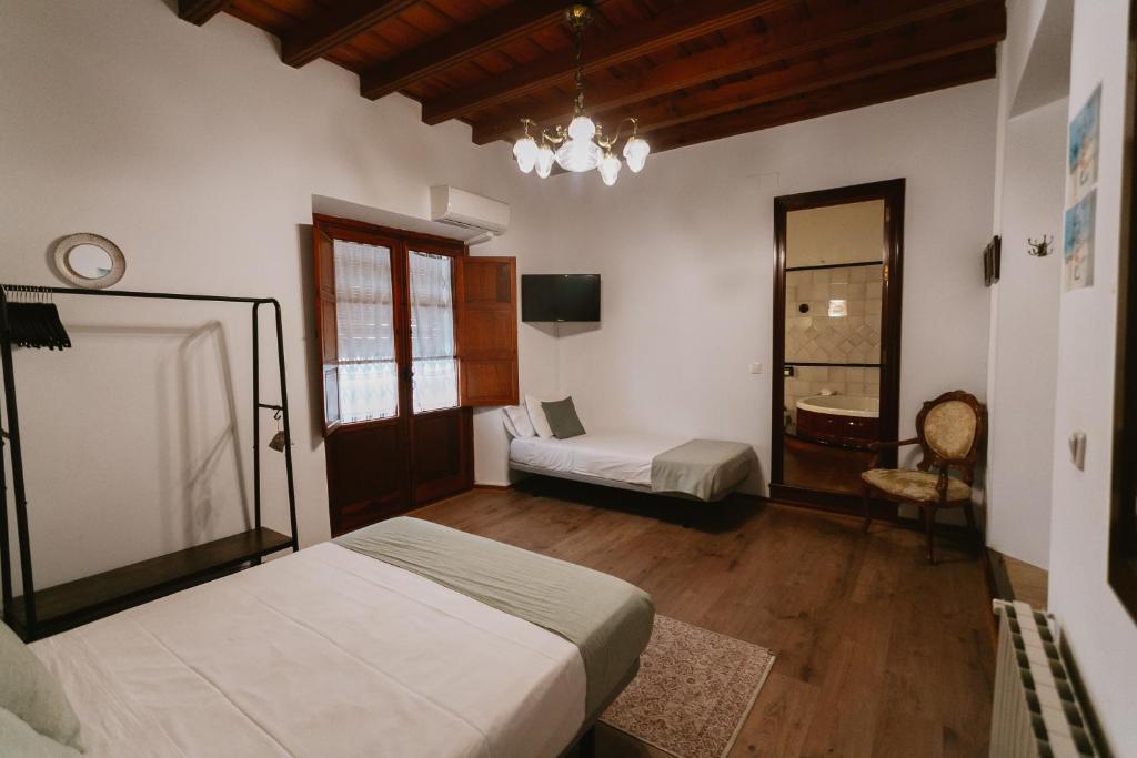 Postel nebo postele na pokoji v ubytování Komodo Casa Maravillas Rooms