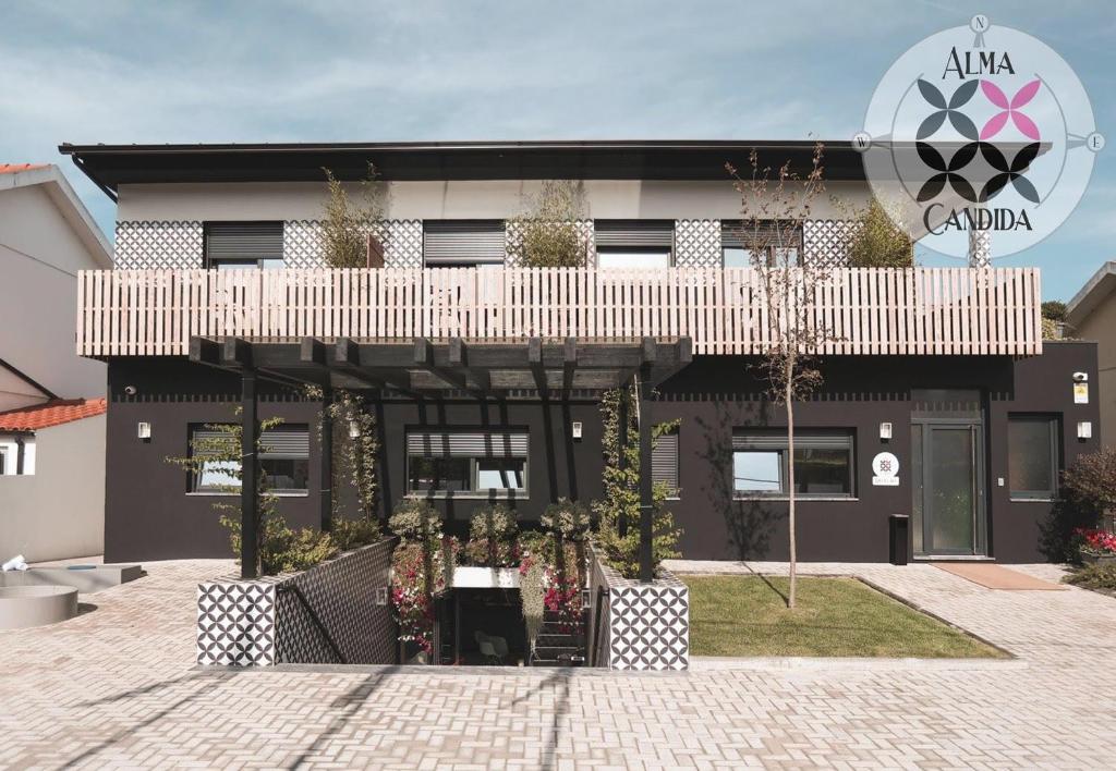 a black and white building with a balcony at Alma Candida 01 in Valença