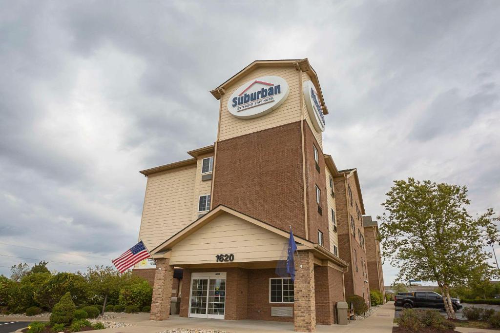 a building with a sign on the top of it at Suburban Studios Clarksville-Louisville North in Clarksville