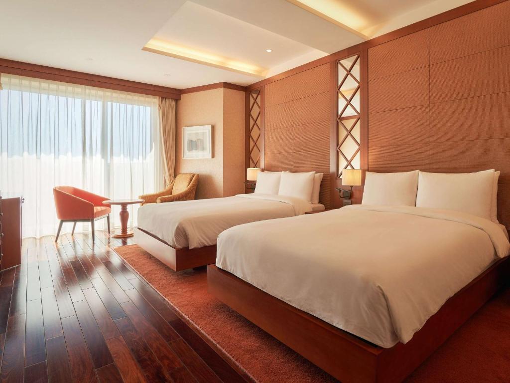 Postel nebo postele na pokoji v ubytování Mercure Ambassador Jeju