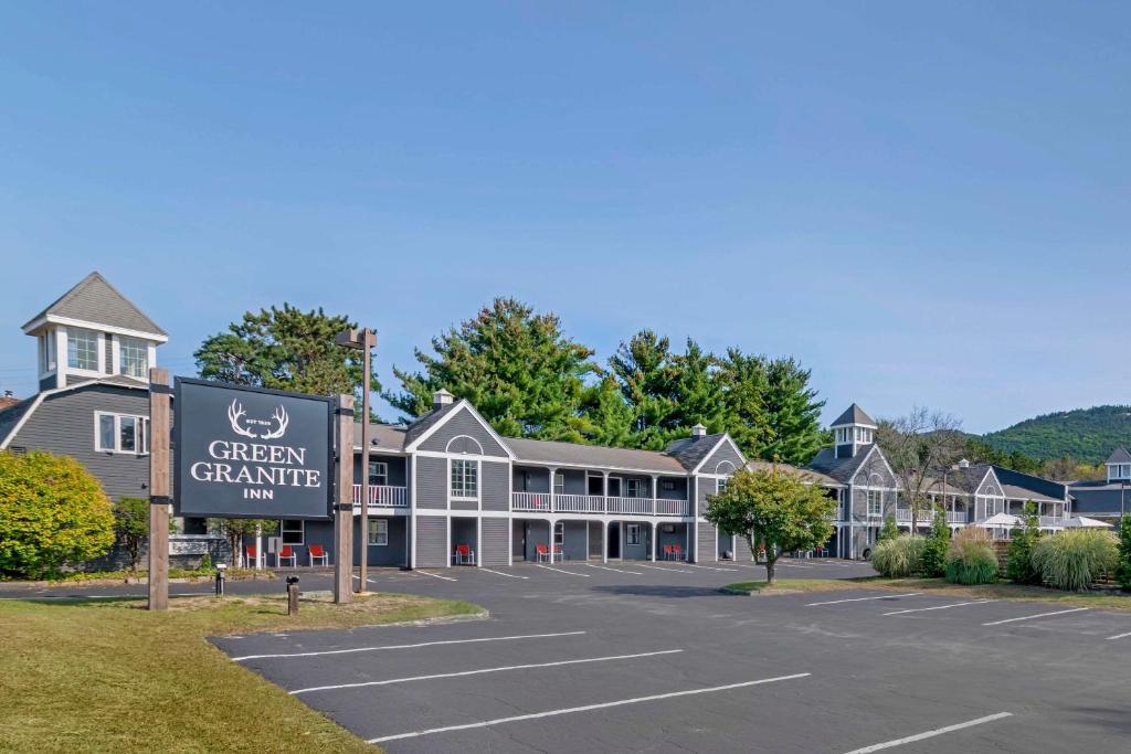 a building with a sign in a parking lot at Green Granite Inn, Ascend Hotel Collection in North Conway