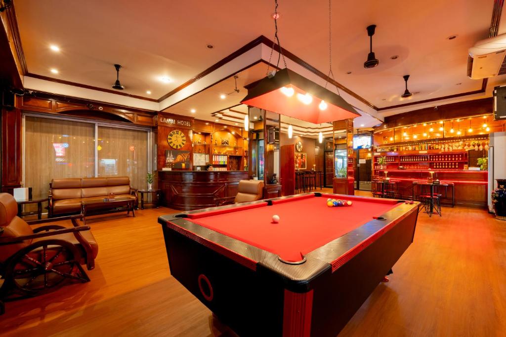 a pool table in a room with a bar at Lamai Hotel in Patong Beach