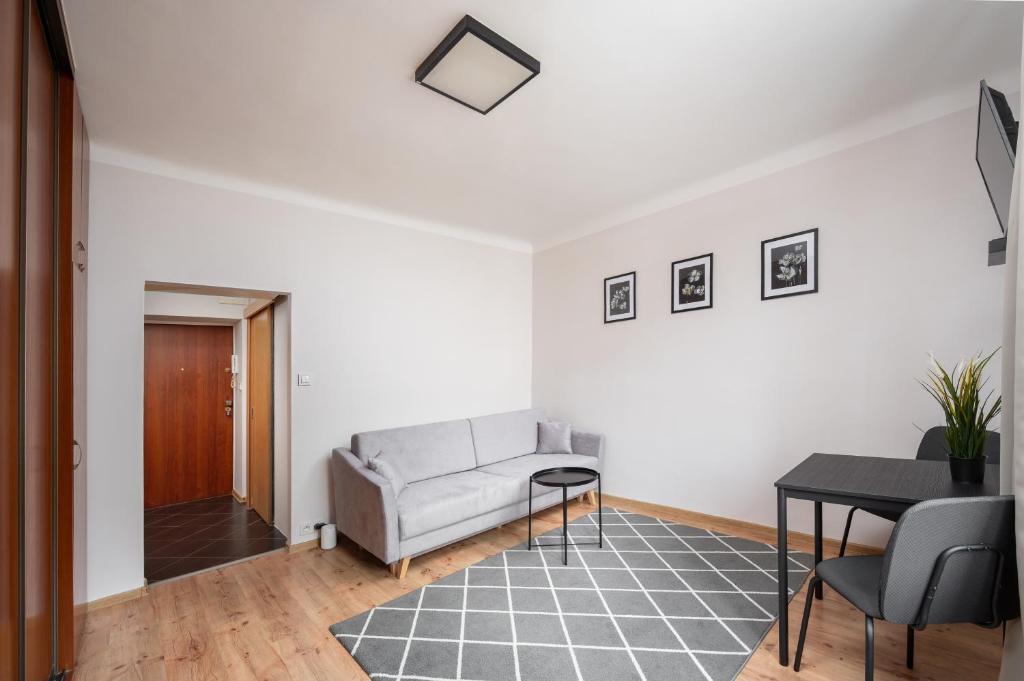 a living room with a couch and a table at Park Praski Standard Studio in Warsaw