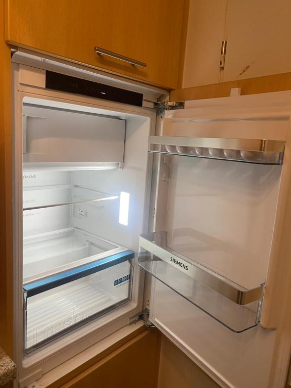 an empty refrigerator with its door open at Im Grünen von Kiel in Kiel