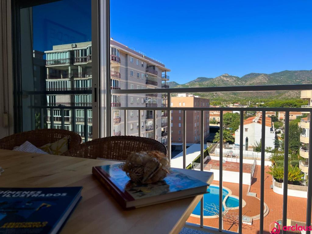 a table with a book and a view of a balcony at Casa Marino in Benicàssim