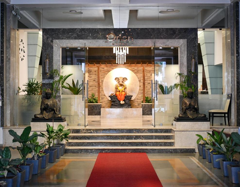 a lobby with a red carpet in front of a building at Hotel Orion Centrally near North Goa & Panjim in Porvorim