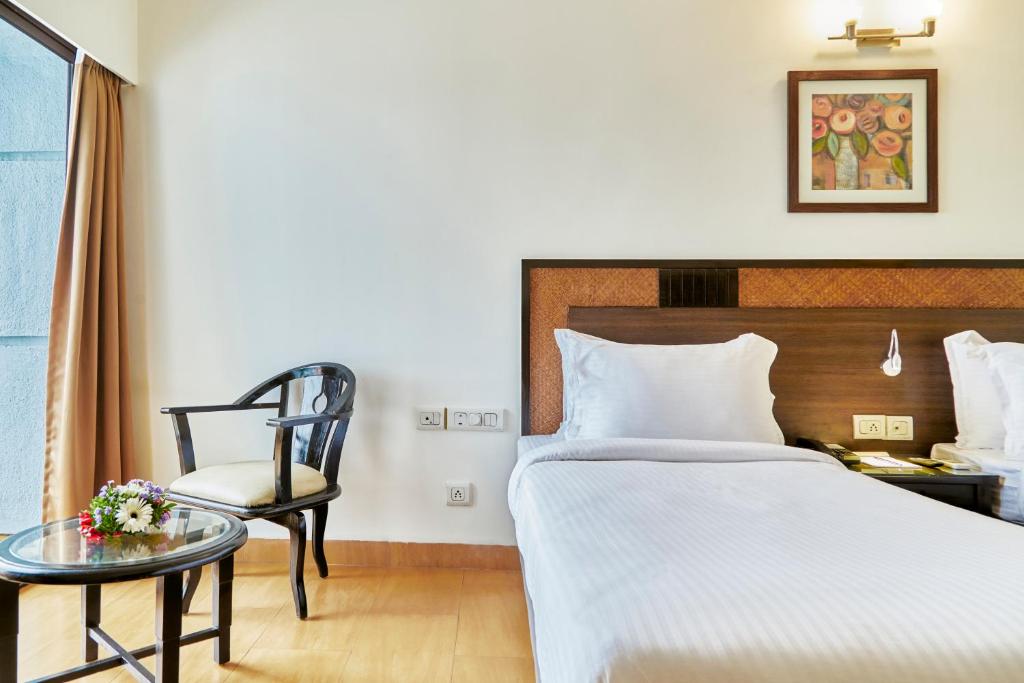 Postel nebo postele na pokoji v ubytování Hotel Orion Centrally near North Goa & Panjim
