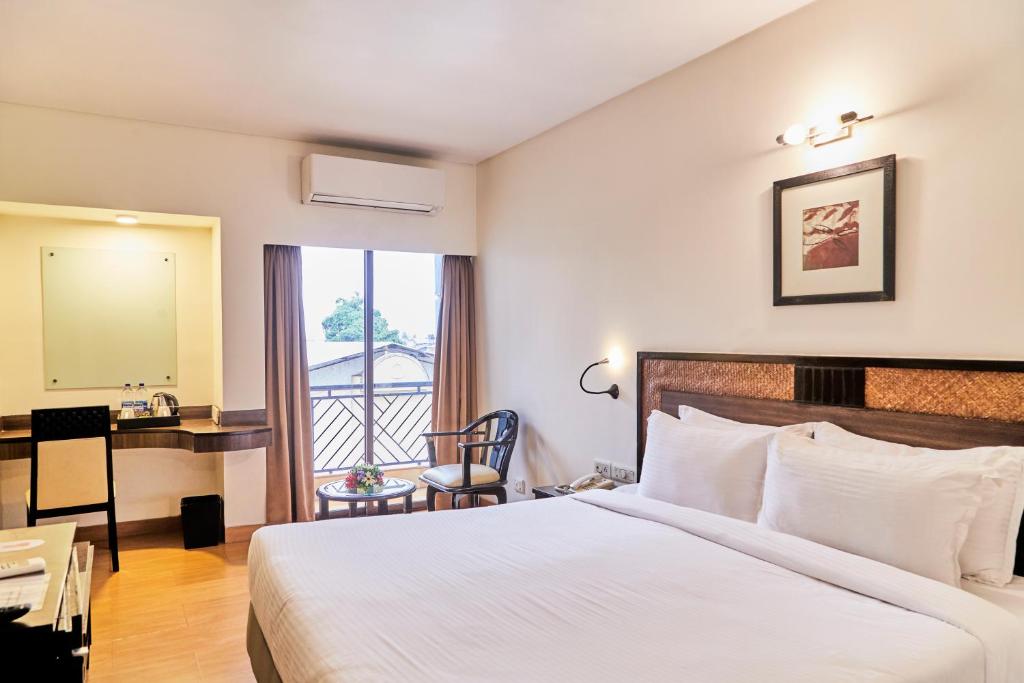 Postel nebo postele na pokoji v ubytování Hotel Orion Centrally near North Goa & Panjim