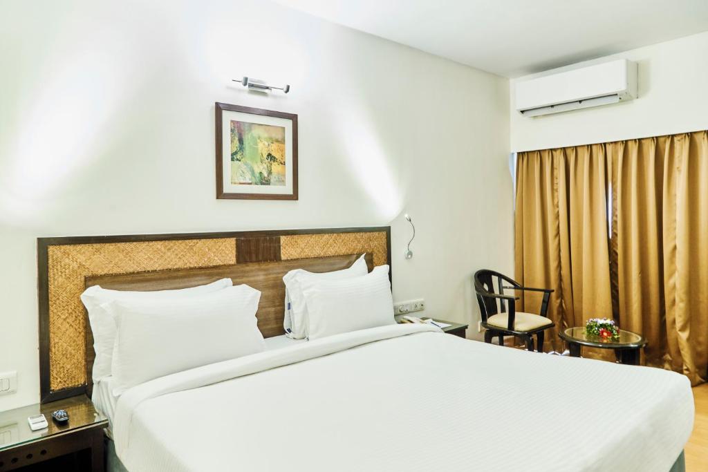 Postel nebo postele na pokoji v ubytování Hotel Orion Centrally near North Goa & Panjim