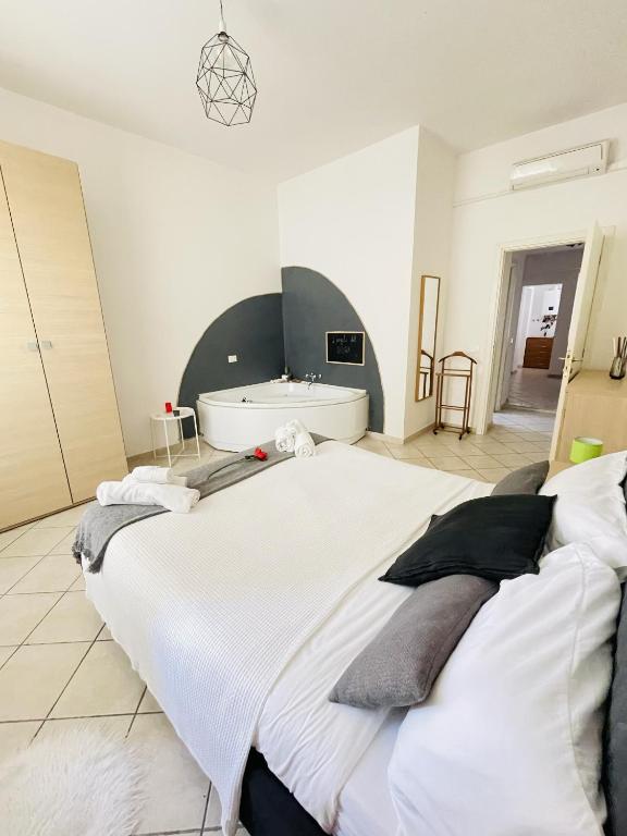a bedroom with a large bed and a bath tub at JacuzziSuite in Livorno