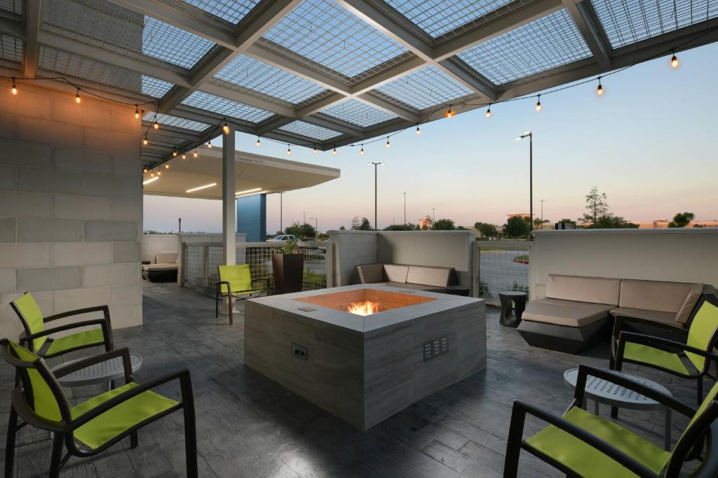 an outdoor patio with a fire pit and chairs at SpringHill Suites by Marriott Texas City in Texas City