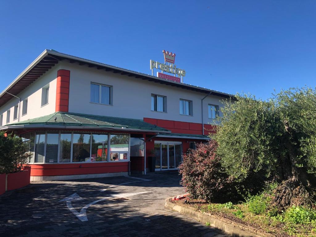 a hotel building with a sign on top of it at Hotel Motel Prestige in Grugliasco