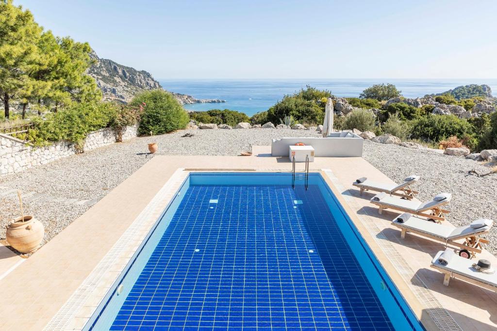a swimming pool with a view of the ocean at Villa Katherina - Tsambika View in Archangelos