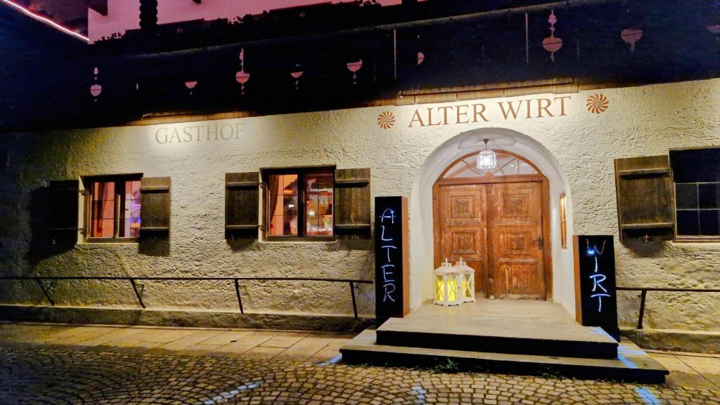 a building with a door and a sign that reads alter wife at Hotel Landgasthof Alter Wirt in Fischbachau