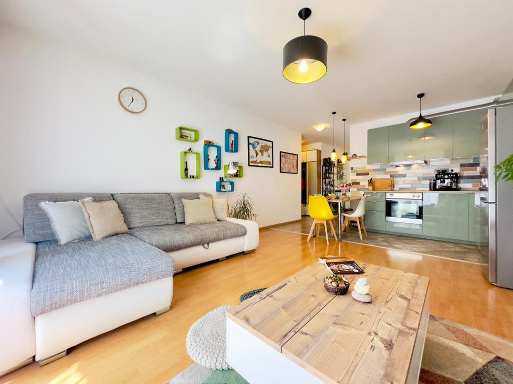 a living room with a couch and a table at Corvin City Apartment - FREE PARKING- in Budapest